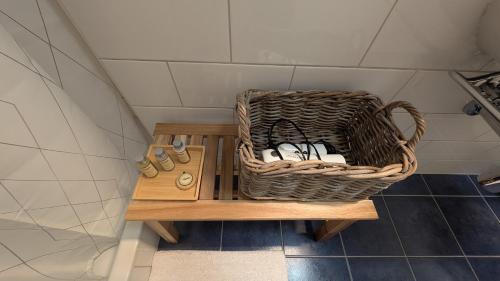 a basket sitting on a wooden table in a bathroom at Casa14 - Swiss houses in Steffisburg