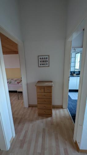a room with a wooden dresser and a bedroom at Casa14 - Swiss houses in Steffisburg