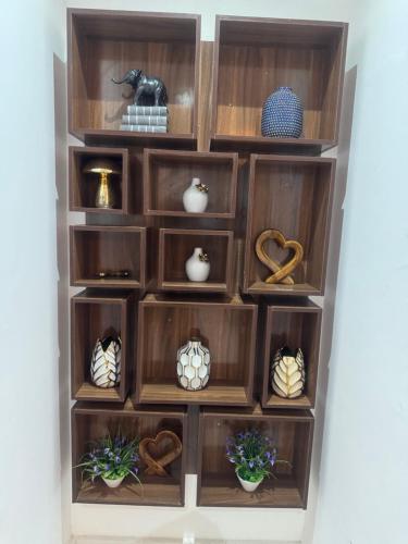 a wooden shelf with vases and vases on it at Gorgeous 4 Bedrooms Single Family Home at Ibeju, Lekki Lagos in Lekki