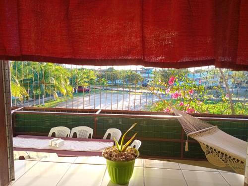 a window with a hammock and a view of a street at Hospedaje Beliz Cambalache in Liberia