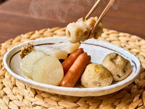 a bowl of food on a wicker table at Daiwa Roynet Hotel Naha Kokusaidori in Naha