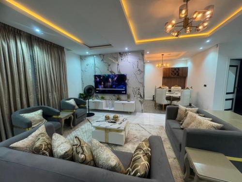 a large living room with couches and a tv at Gorgeous 4 Bedrooms Single Family Home at Ibeju, Lekki Lagos in Lekki