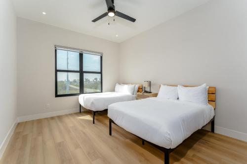a bedroom with two beds and a ceiling fan at Waterfront Home with Pool Spacious Bay , Sleeps 16 in Port Isabel