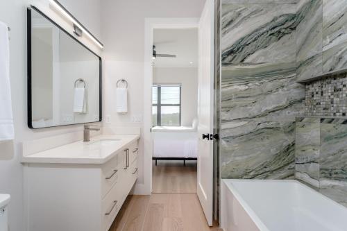 a bathroom with two sinks and a shower at Waterfront Home with Pool Spacious Bay , Sleeps 16 in Port Isabel