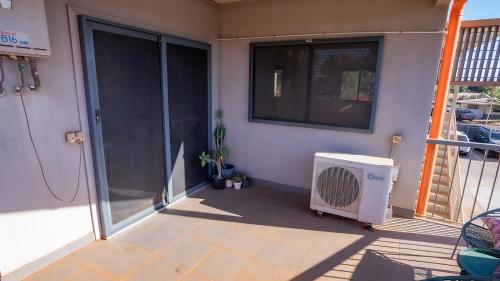 a patio with a window and a heater on a house at Suburban Sanctuary South Hedland in South Hedland