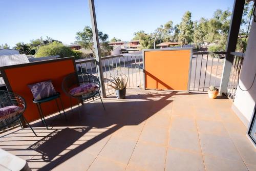 a balcony with chairs and a fence at Suburban Sanctuary South Hedland in South Hedland