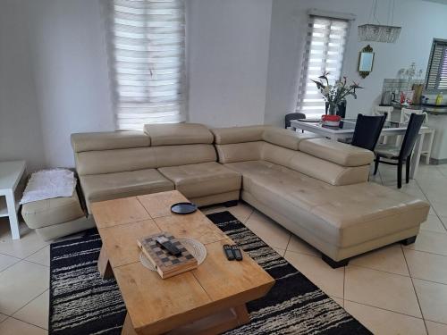 a living room with a couch and a coffee table at Turdeluxe company 4 room apartment with breakfast in Rechovot