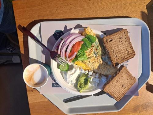 a plate of food with a salad and bread at Turdeluxe company 4 room apartment with breakfast in Rechovot