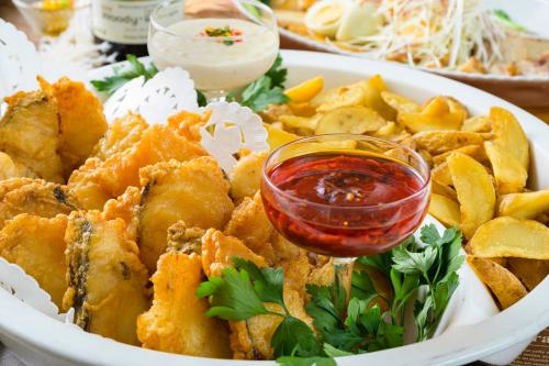 a plate of food with a bowl of dipping sauce at Senkeien Tsukioka Hotel in Kaminoyama
