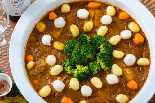 a pot of stew with broccoli and balls in it at Senkeien Tsukioka Hotel in Kaminoyama