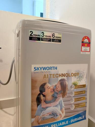 a refrigerator with a poster of a man and woman kissing at Near Airport K Avenue Family Room in Donggongon
