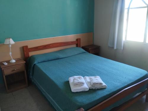 a bedroom with a bed with two towels on it at Hotel rural Concordia in Concordia