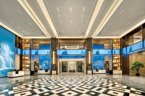 a lobby of a building with blue walls at Holiday Inn Express Rugao City Center, an IHG Hotel in Nantong