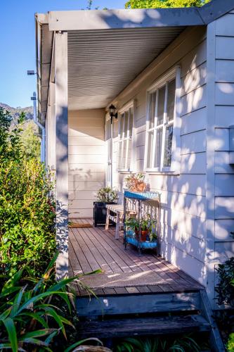 a porch of a house with a chair on it at The Rustic Nest Yarramalong in Yarramalong