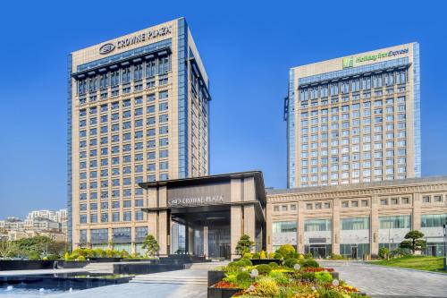 two tall buildings in front of a building at Holiday Inn Express Rugao City Center, an IHG Hotel in Nantong