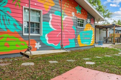 a building with a painting on the side of it at All King Beds & TVs in Every Room, Perfect for Large Groups in Palm Bay