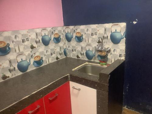 a kitchen with a sink and blue vases on the wall at Swoyambhu Home Stay in Kathmandu