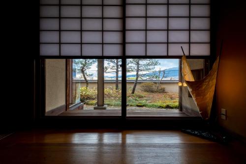 a window in a room with a view of a yard at Senkeien Tsukioka Hotel in Kaminoyama