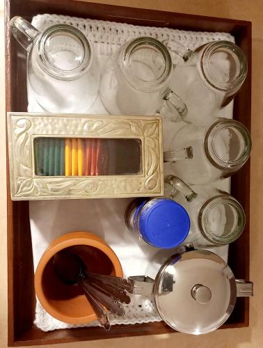 a wooden box filled with utensils and jars and bowls at Luminares in Humahuaca