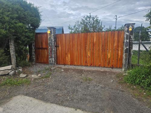 a wooden gate in front of a fence at MejorCadaDia Eco-Farm in Paso Ancho