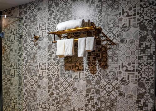 a bathroom with a shower with towels on a wall at Homestay Art Bát Tràng in Kim Quan