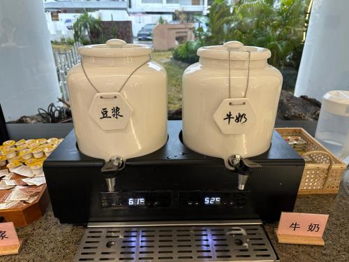 two vases sitting on top of a toaster at Yangshuo Pony Hotel - Yulong River in Yangshuo