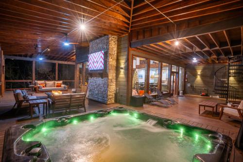 a jacuzzi in the middle of a house at Brand New Luxury Mountain Retreat Awaits You! in Broken Bow