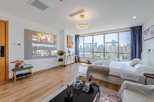 a bedroom with a bed and a large window at Qingdao Shanhaiji Sea View B&B Wusi Square Branch in Fushansuo