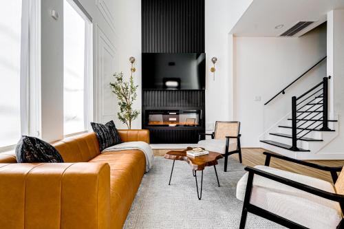 a living room with a couch and a fireplace at Urban Oasis with Top Houston Attractions nearby in Houston