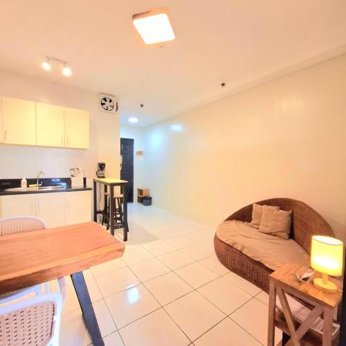 a living room with a bed and a kitchen at BREATHTAKING BAYVIEWS - 1-5 BR Luxury and Superior Condos with Panoramic Bay Views, Balcony, Gym, Pool & Netflix - Housekeeping Available - in Manila