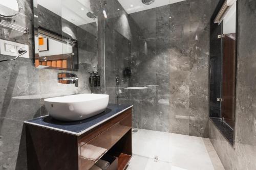 a bathroom with a sink and a shower at AVA Hotel Chandigarh Zirakpur in Zirakpur