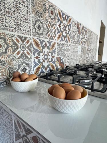 two bowls of eggs on a counter in a kitchen at Urban Nest Hostel in Santa Ana