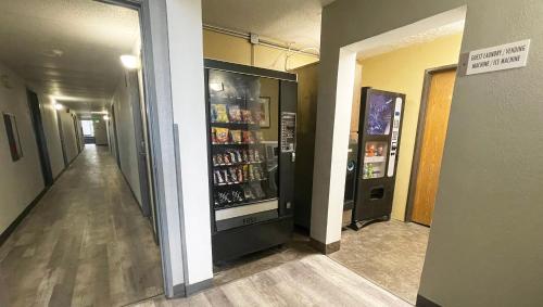 a hallway with a drink cooler in a building at Magnuson Hotel Fort Wayne North - Coliseum in Fort Wayne