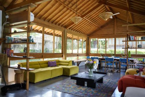 a living room with a yellow couch and a table at Cozy Room Monkey View in Kaba-Kaba in Tumbak Bayuh