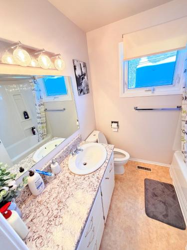 a bathroom with a sink and a toilet at Cozy main floor, 03 Bedrooms, close to Downtown REGINA in Regina