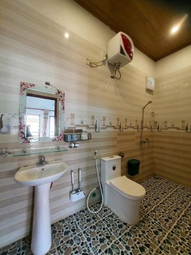 a bathroom with a toilet and a sink at JAMERIK TACO BAR - Hostel in Ninh Binh