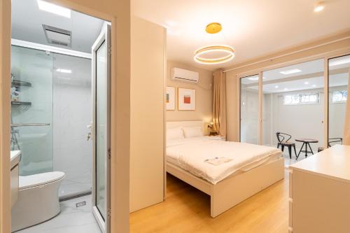 a bedroom with a bed and a shower at Shanghai Hills&Linghu's Transit-Prime Suite-Line 2, Huamu Rd 788, Direct to Key Spots & SNIEC in Shanghai