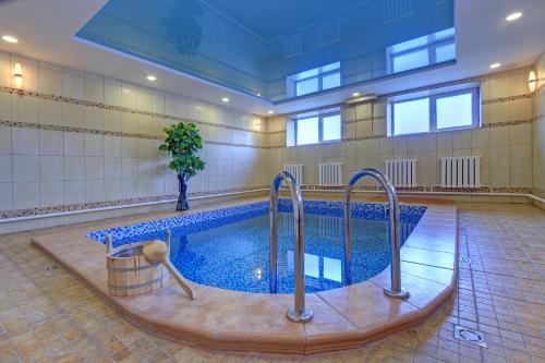 a swimming pool in a large room with at Resident Hotel Almaty in Almaty