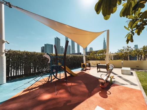 a patio with a canopy and chairs on a roof at Brand New! Downtown views located on Dubai Mall in Dubai