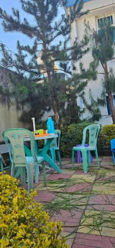 a group of tables and chairs on a patio at Avi Guest House in Addis Ababa