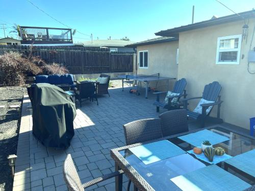 a patio with chairs and a table and a table at Butterfly Preserve & Sand Dunes STR49 in Grover Beach