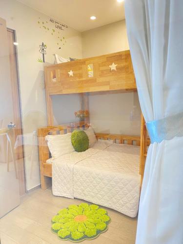 a bedroom with a bunk bed and a rug at T-Plantino - Căn hộ Codotel The Sóng 5 Sao - Free swimmingpool, Gym, Sauna in Vung Tau