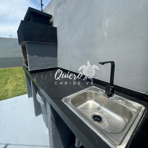 a stainless steel sink in a trailer with a sign on it at Tucacas Casa del Mar Caribe in Tucacas