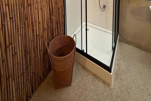 a trash can in a bathroom next to a shower at Balai Balatong Ilocos near Laoag Airport in Raraburan