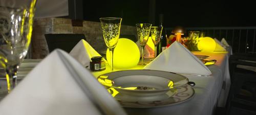a table with yellow plates and wine glasses on it at Villa Alizee in Port Louis