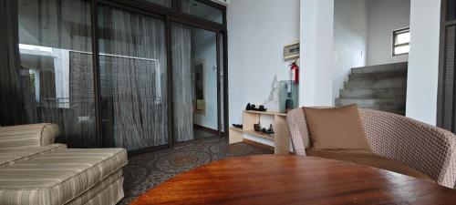 a living room with a couch and a table at Villa Alizee in Port Louis