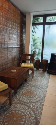 a living room with a couch and a table at Villa Alizee in Port Louis