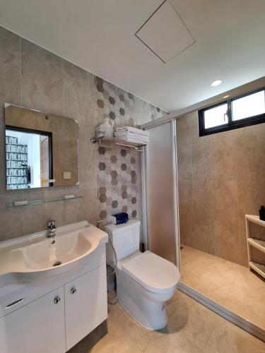 a bathroom with a toilet and a sink at Villa Ten - Swing screw in Guilin