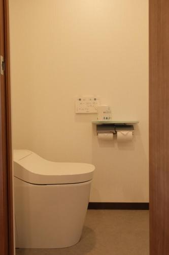 a bathroom with a toilet and a shelf on the wall at Nihonbashi Royal in Osaka