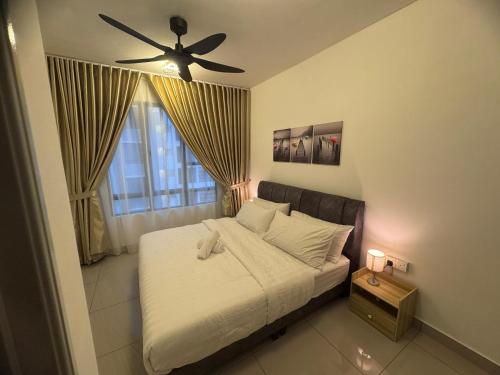a bedroom with a bed with a ceiling fan at Raycation Homestay in Johor Bahru